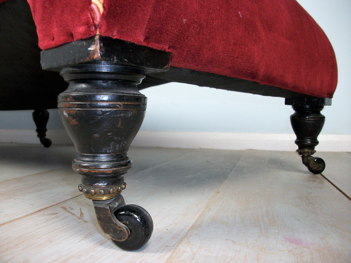 turned and ebonized legs with brass and porcelain castors